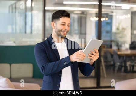 Middle Eastern businessman working on digital tablet in coworking office Stock Photo