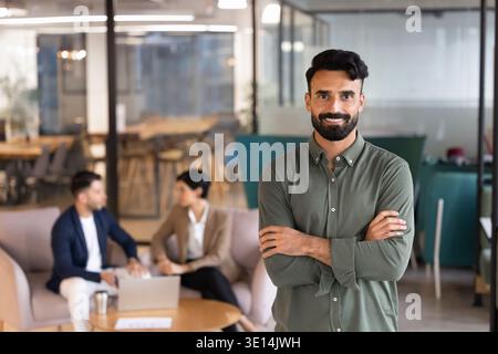 Middle Eastern businessman, team member standing with arms crossed Stock Photo