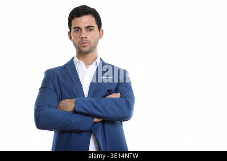 Studio shot of young handsome Hispanic businessman with arms crossed Stock Photo