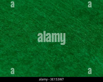 A high-resolution macro close-up showcasing the dense and fuzzy texture of a green felt or fleece fabric. Stock Photo