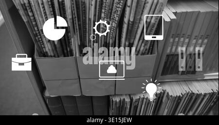 Displaying three cardboard holders with upright magazines on study shelf showing laptop cloud icon Stock Photo