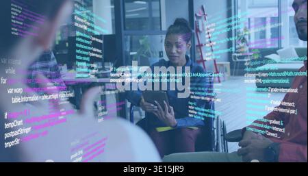 Leading woman in wheelchair holding tablet in glass room in denim jacket, displaying code overlay Stock Photo