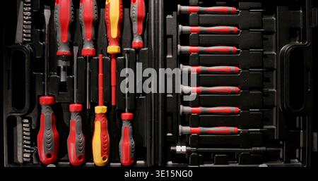 Toolset with assorted screwdrivers and attachments organized in a case for easy access and storage in a garage or workshop Stock Photo