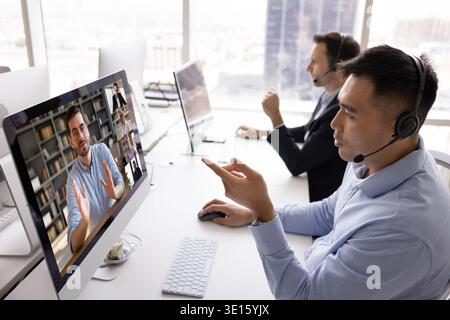 Professional multiethnic team service consultants managing video conference calls Stock Photo