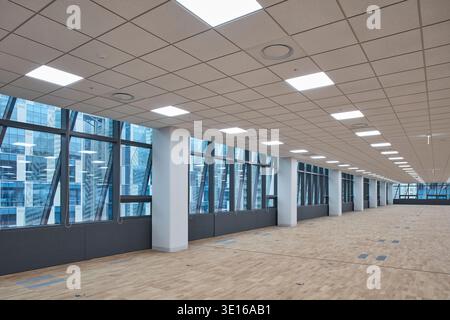 Bright open-plan commercial floor with perimeter glazing and long sightlines. Stock Photo