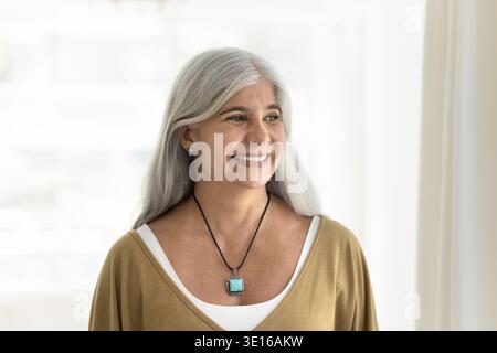 Middle-aged woman looking with smile into distance Stock Photo