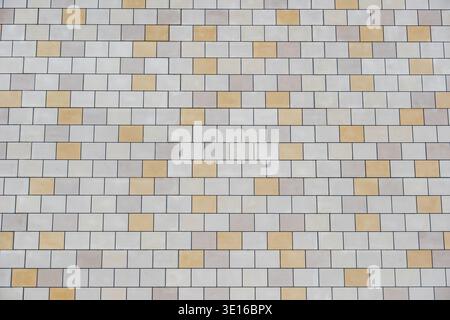 Building facade featuring rectangular stone tiles forming a geometric pattern Stock Photo
