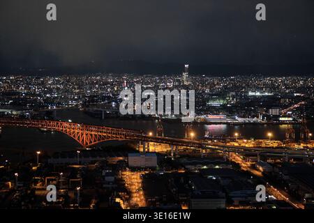 Aerial view of the illuminated waterfront and harbor at night ...