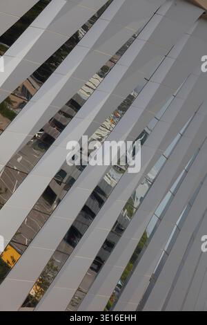 Close-up of white curved facade ribs creating an abstract architectural pattern. Stock Photo