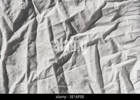 White fabric shows many wrinkles and folds, forming an interesting abstract texture Stock Photo