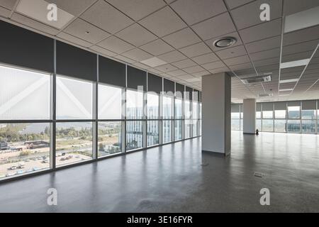Empty corner office with full-height glazing and city views. Stock Photo