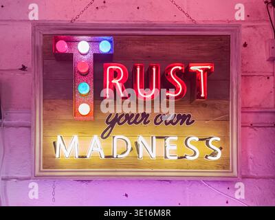 Trust your own madness neon sign display at Gods Own Junkyard, London, UK Stock Photo