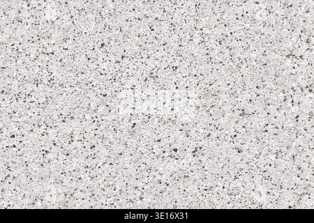 Macro view of small quartz and granite pebbles on a white background. Dense mineral grain texture, ideal for construction, interior design, and archit Stock Photo