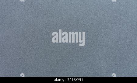 Gray metallic surface displaying abstract grit texture with small particles Stock Photo