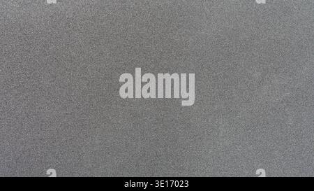 Grey gritty texture creating an abstract noise background surface Stock Photo