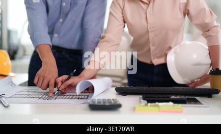 Adult engineers hands analyze construction blueprints design project team collaboration office workplace architectural planning professional discussio Stock Photo