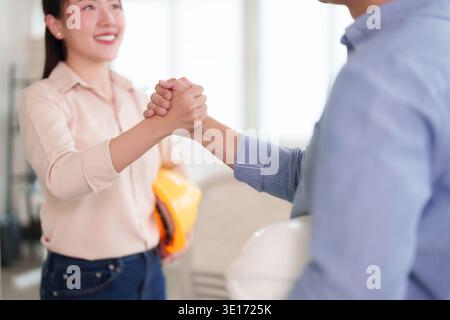 Two skilled engineers or architects seal a new construction deal Collaborative business partnership leads to a successful project outcome Stock Photo