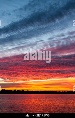 Colourful cloudscape of altocumulus clouds at sunset, IJsselmeer, Netherlands Stock Photo