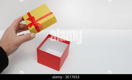 Red box sits open on white surface. Bright colors suggest celebration or surprise. Clean background emphasizes the gift's elegance. Ideal for holiday, Stock Photo