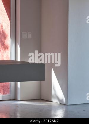 Soft pink wall detail with sunlight in a minimal interior. Stock Photo