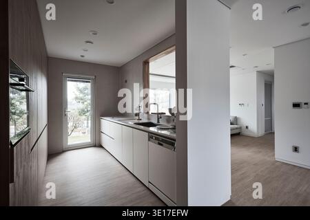 Kitchen view toward a bright living room in a modern home. Stock Photo