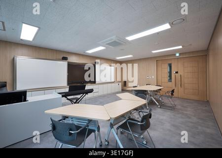 Small classroom or meeting room with movable desks. Stock Photo