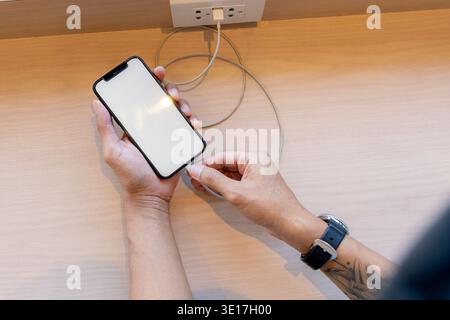 Smartphone charging,plugged into electrical outlet Stock Photo