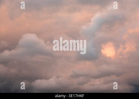 A beautiful display of soft pastel clouds during sunset, casting warm hues across the sky. This tranquil scene captures the serene and dreamy atmosphe Stock Photo