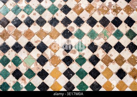 Explore the intricate vintage handmade ceramic tile design found in Marrakech, Morocco. Immerse yourself in the stunning geometric patterns and vibran Stock Photo