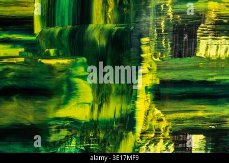 A captivating abstract acrylic painting featuring vibrant green hues, flowing textures, and dynamic brush strokes that create a lush and immersive bac Stock Photo