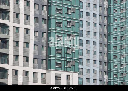 Residential facade with green glass and repeating balconies. Stock Photo