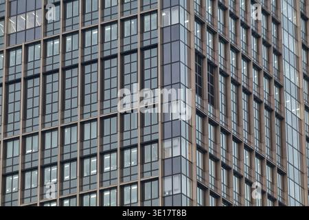 Tight crop of office facade with repeating grids of windows and mullions. Stock Photo