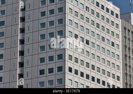 Tight crop of office facade with a regular window grid. Stock Photo