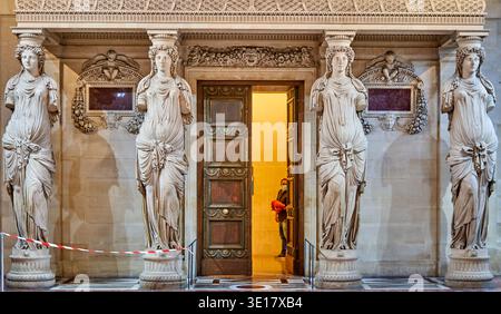 This image captures the iconic Salle des Caryatides (Hall of the Caryatids) in the Louvre Museum, Paris, France. Four magnificent marble... Stock Photo