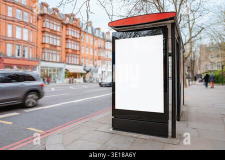 Blank advertising poster at bus stop shelter on busy city street with cars and historic buildings in background, bus stop advertisement mockup Stock Photo
