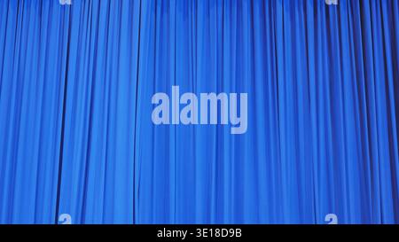 Blue theater curtain with vertical folds creating a dynamic texture backdrop Stock Photo