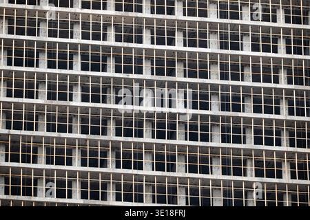 Concrete building framework under construction showing grid pattern of unfinished facade Stock Photo