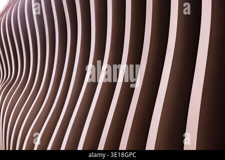 Modern wavy architectural facade showing parallel lines and rhythmic brown design Stock Photo