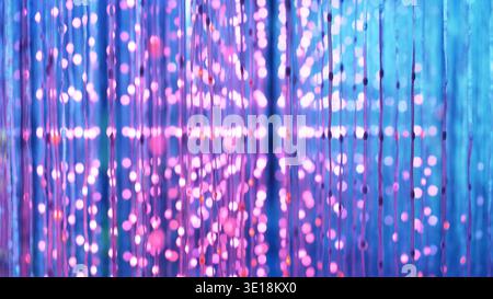 Abstract glowing pink and purple lights creating a vibrant bokeh background Stock Photo