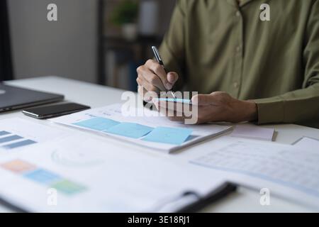 Business man working from home taking reading and writing notes in note Stock Photo
