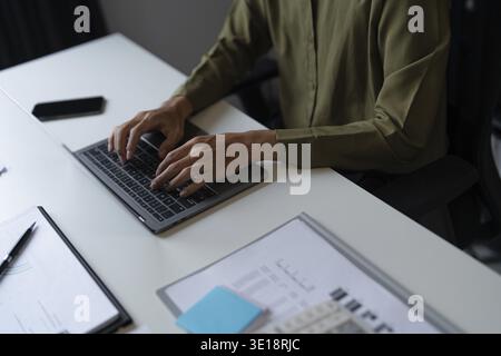 Closeup of Businessman Hands Typing on Laptop in Office Stock Photo