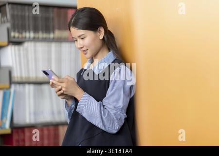 Asian woman chats with AI on mobile to enhance knowledge Stock Photo