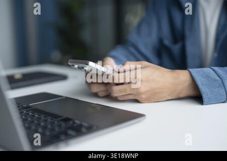 Man Using Smartphone in Modern Office Technology Stock Photo