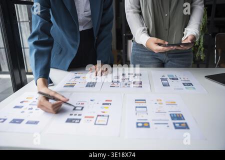 Developer team brainstorming user interface and experience designs for mobile application ux ui graphic prototype Stock Photo