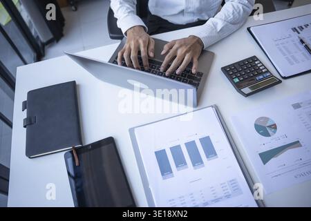 Successful Businessman Using Laptop in Modern OfficeSuccessful Businessman Using Laptop in Modern Office Stock Photo