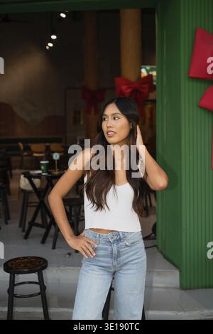 Portrait of beautiful young Asian woman standing in restaurant Stock Photo