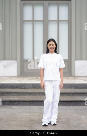 Full Length Portrait of Young Thai Woman Smiling Outdoors in Casual Clothing Concept Stock Photo