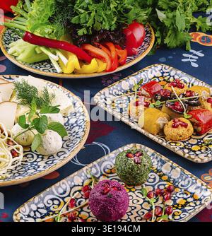 Spread of colorful and flavorful georgian cuisine dishes, featuring a variety of traditional appetizers, vegetables, and spices, served on beautifully Stock Photo