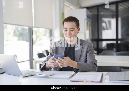 Asian Business man working with laptop. Young business man thinking Concentrated at work Stock Photo