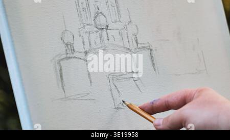 Artist sketching building on canvas using pencil Stock Photo